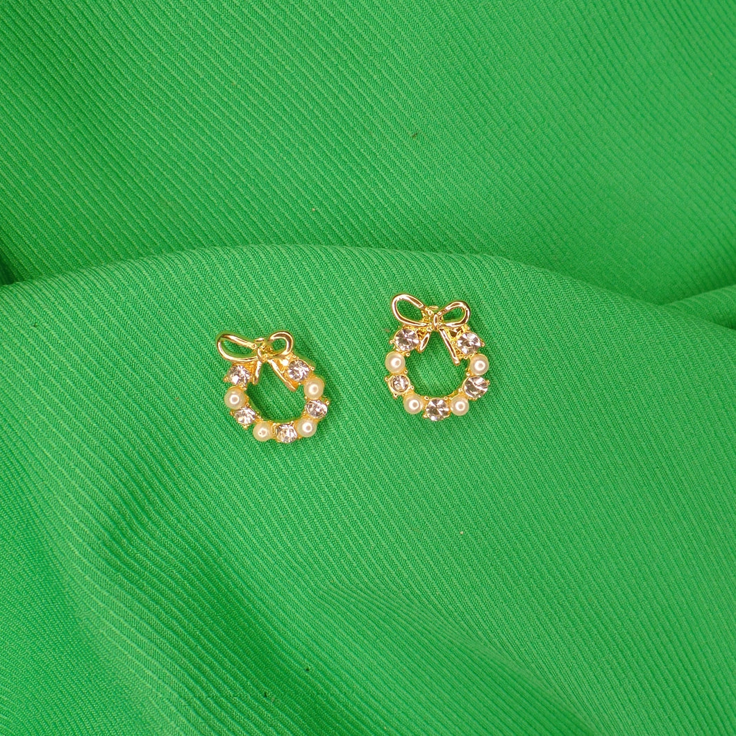 Aretes de zirconia con moño - chapa de oro 18k